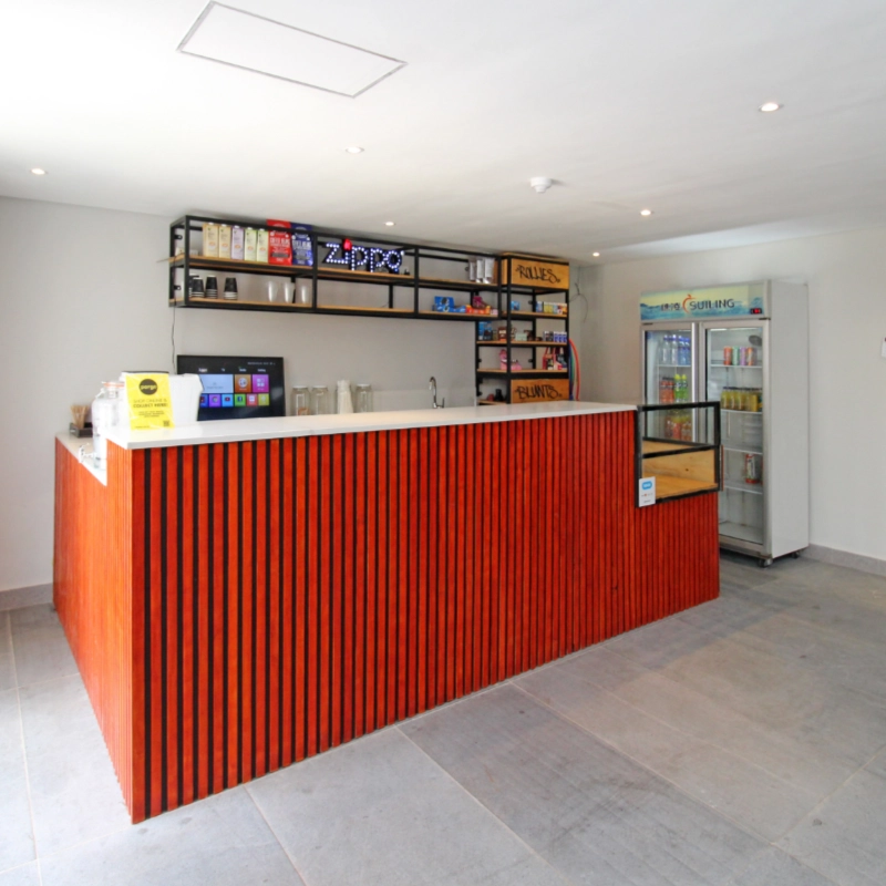 Counter in the deli with a fridge of cooldrinks